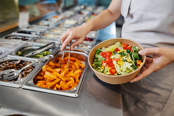 a person serving from the cafeteria