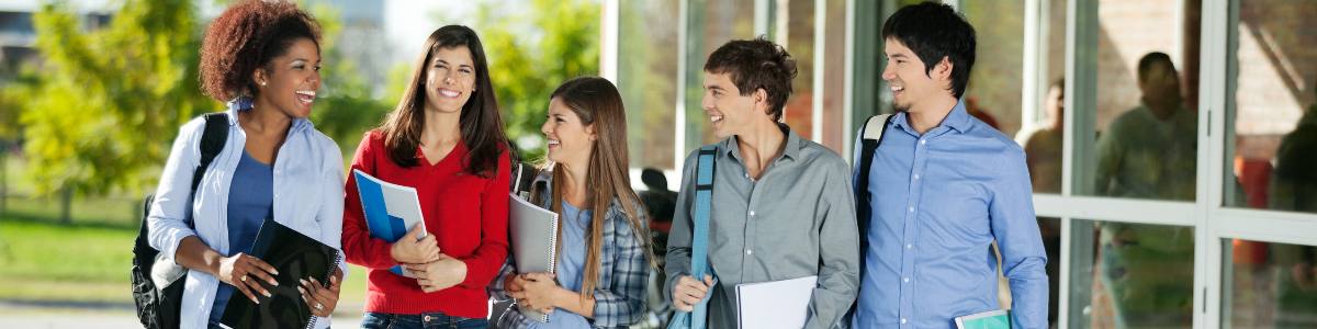 students walking and talking in a hallway A group of students walking.
