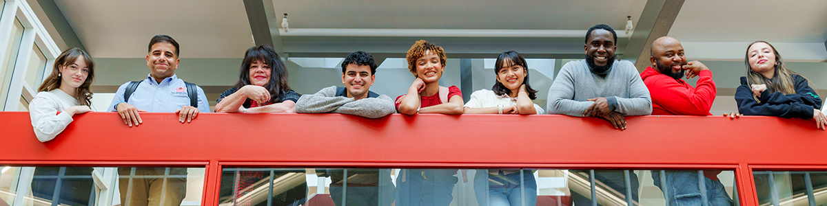 A group of students looking down from the E-Building stairway A group of students looking down from the E-Building stairway