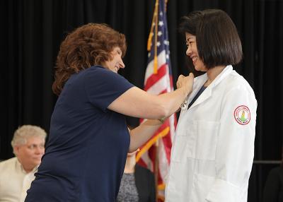 student receiving her medical imaging pin