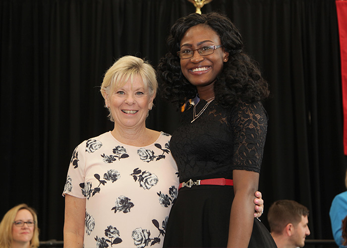 female student posing with faculty member