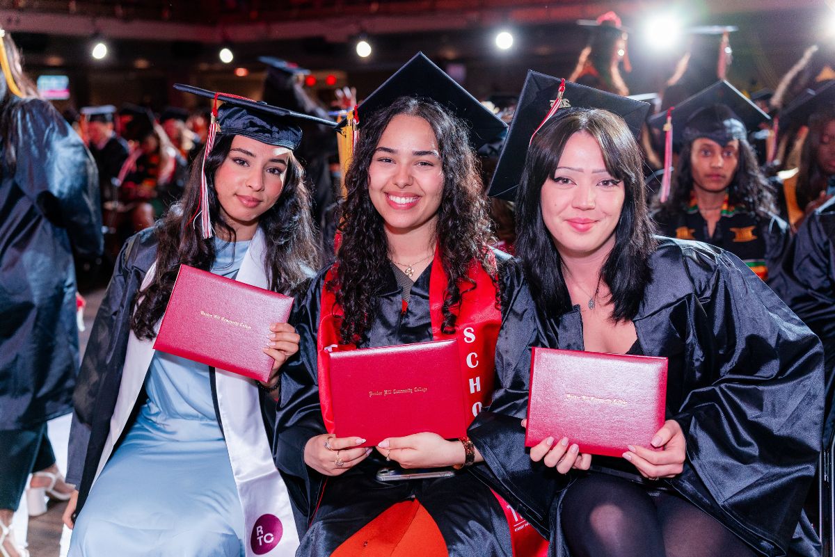 Students at commencement with diploma