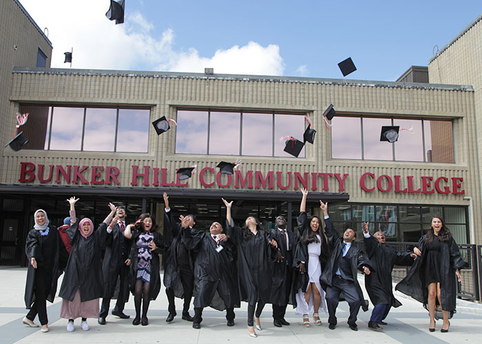 CCIP gradutes throwing their caps outside