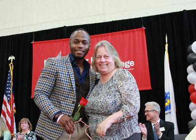 male student posing with nursing faculty member