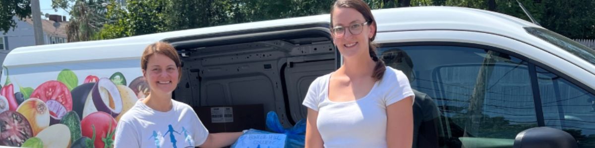 two people standing in front of van 