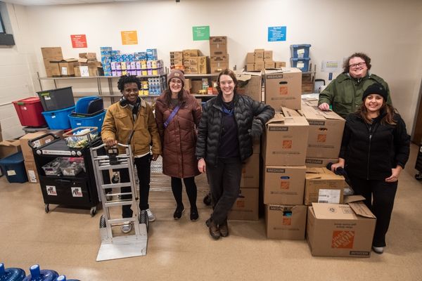 People posing in front of boxes