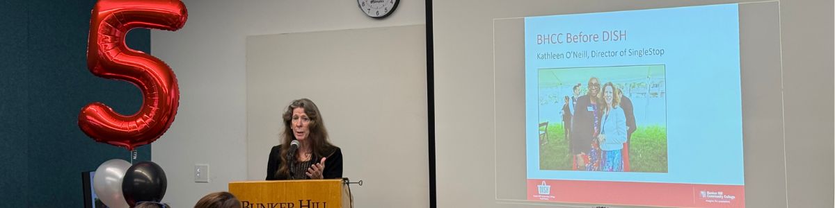 Kathleen speaking at the podium 
