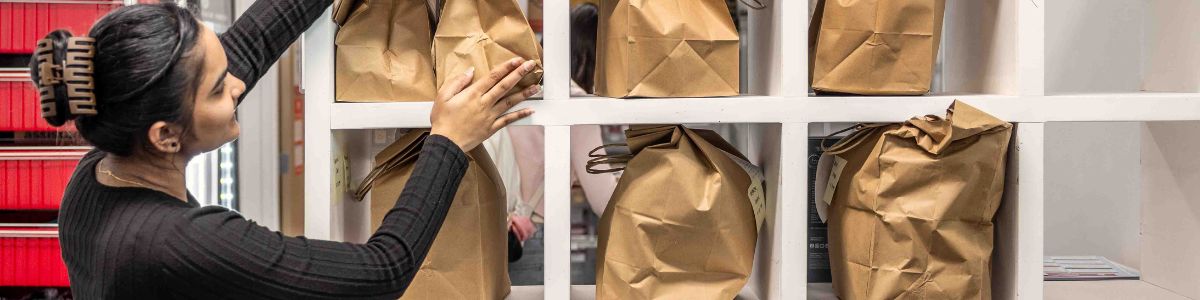 student organizing DISH paper bags 