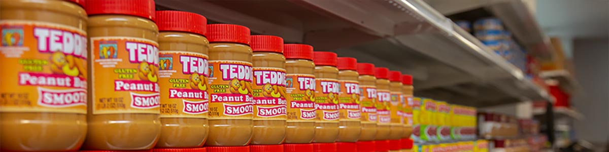 A shelf of peanut butter jars 