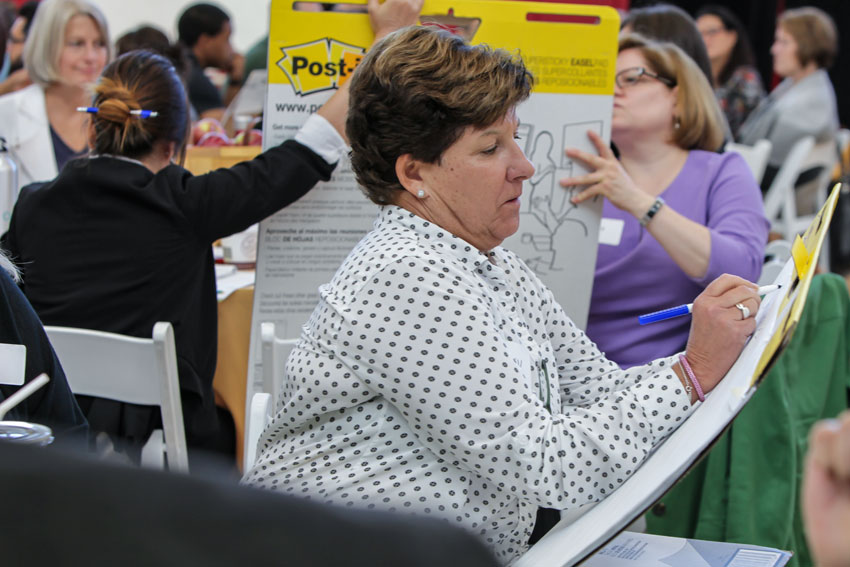 BHCC employee writing at her table