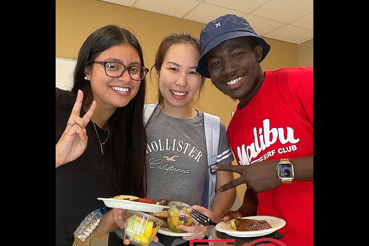 Students eating food at Chelsea birthday week event