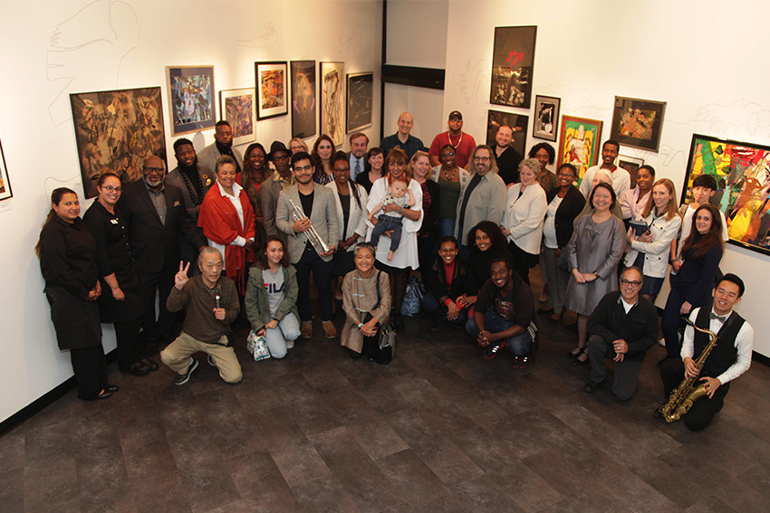 group of people posing in the art gallery