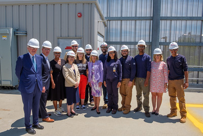 Jill Biden with BHCC and Eversource people wearing white safety helmoets