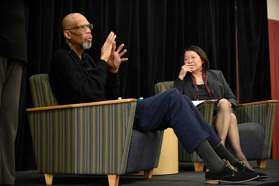 Kareem Abdul-Jabbar talking on stage with BHCC President Pam Eddinger