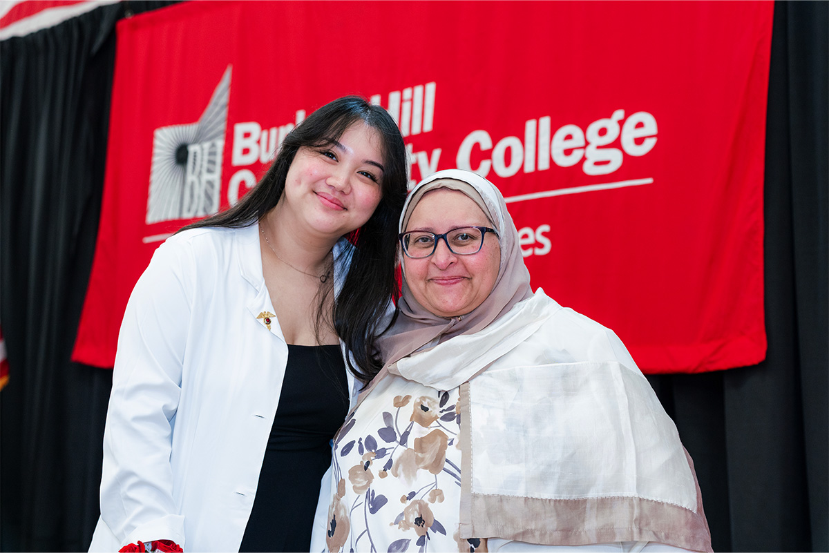 student and faculty on stage