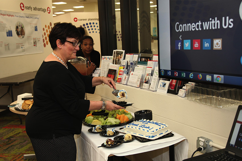 Associate Provost cutting a cake