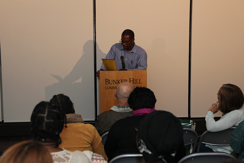 main speaking at a podium