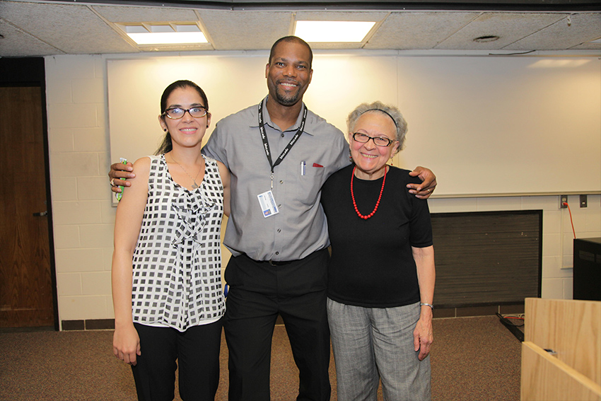 a man standing with two women