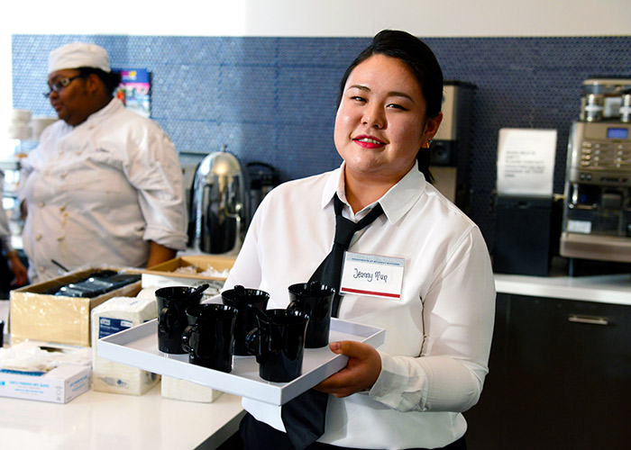 BHCC student with serving tray