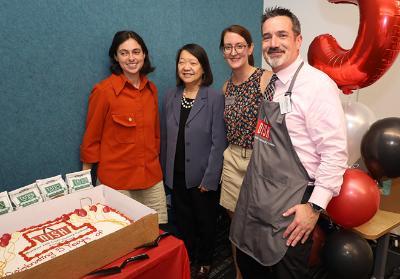 President Eddinger (second from left) celebrates DISH Food Pantry anniversary alongside DISH staff members Emery Spooner (far r left) and Chelsea Alexander (second from right) and Assistant Dean of Students Will Cribby (far right)
