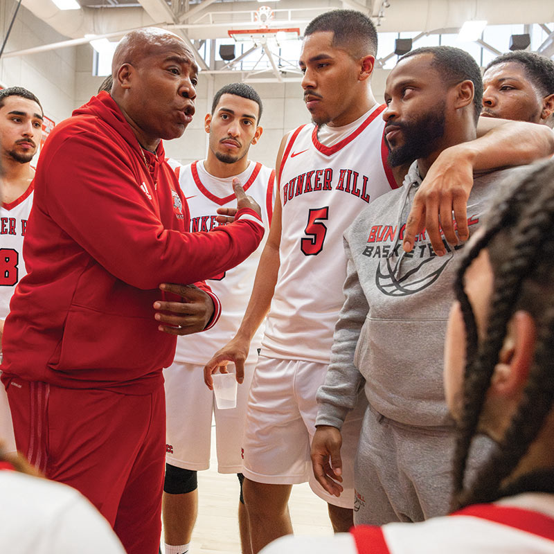 Coach Jones, Gio and the team on sideline.