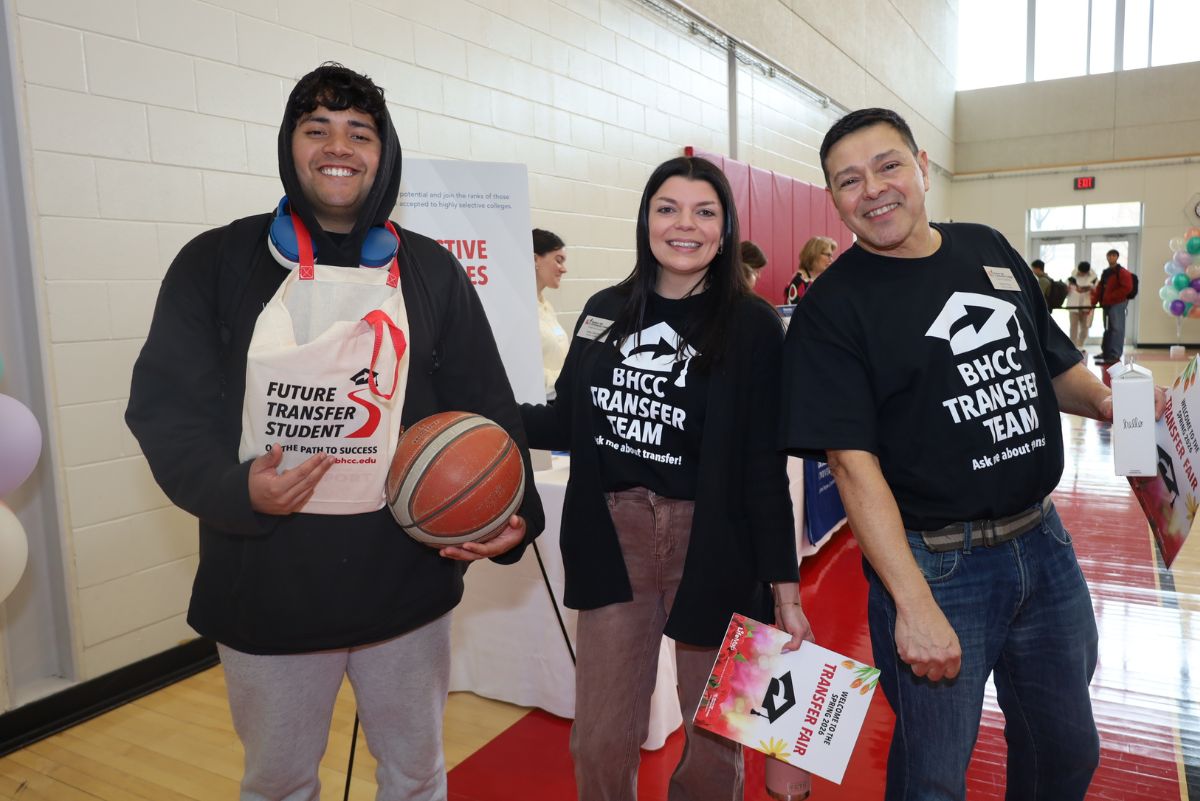 2026 Transfer Fair Team posing with a student