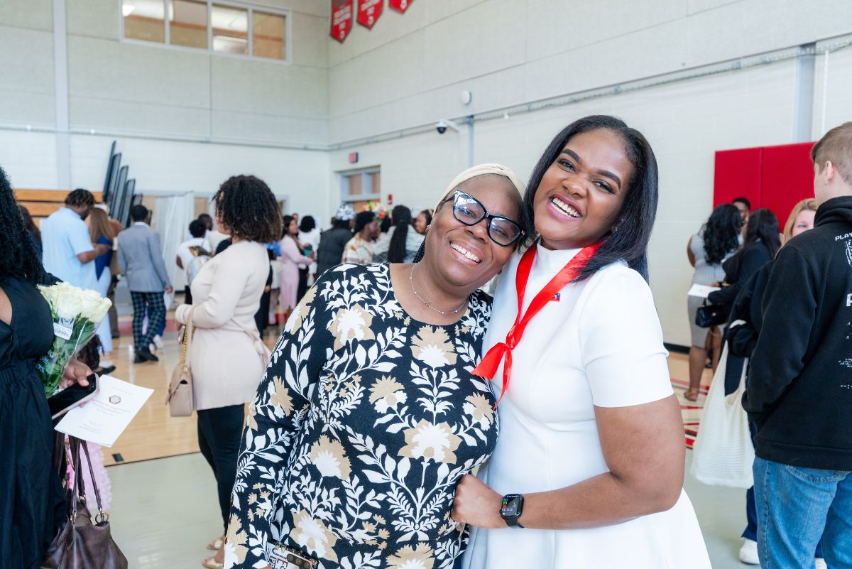 Graduate and family member posing