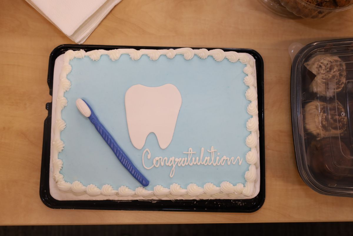 congratulatory cake with a toothbrush and tooth design