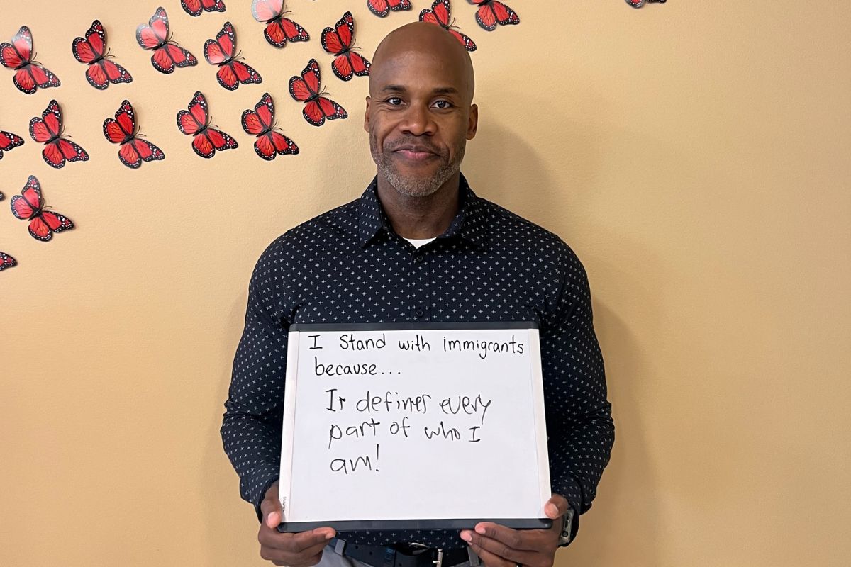 Evans posing with a sign