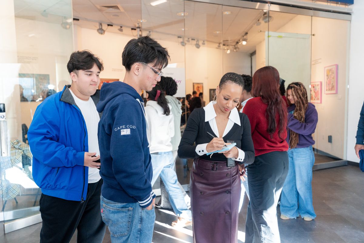 Monique signing her autograph