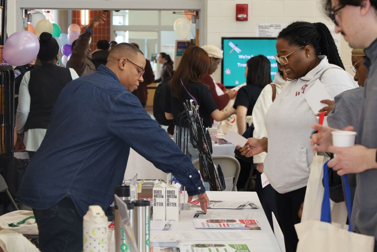 student at a transfer fair table
