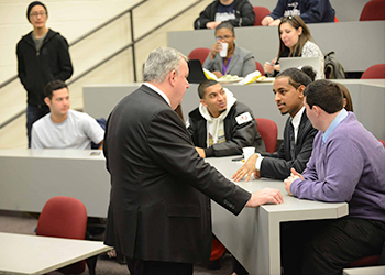 Ed Davis speaking with students