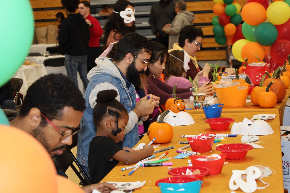 people painting pumpkins