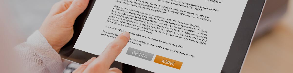 someone signing a form on an ipad 