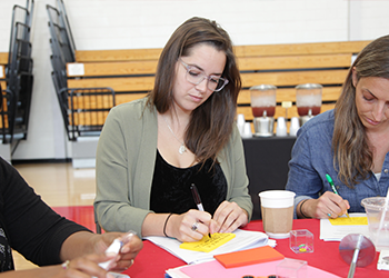 taking notes at the retreat table discussion