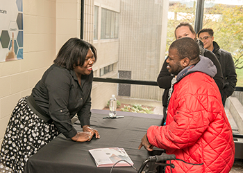 Shoshana Johnson speaking to a student at the book signing