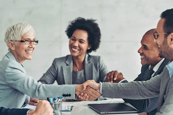 people shaking hands at a meeting